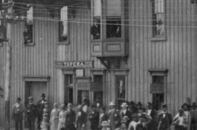 Depot entrance at left by boxcars.