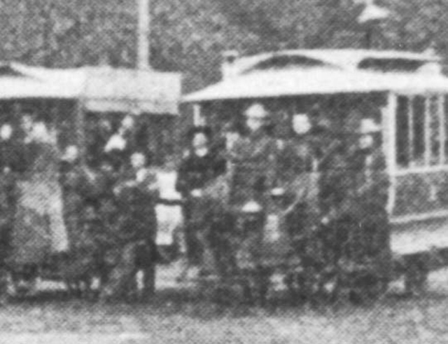 Detail of people on cars at right