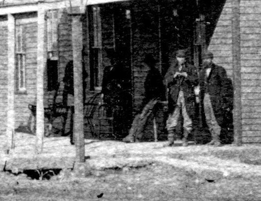 Front lower floor, two men in shadow.