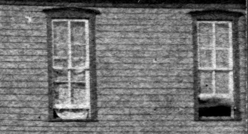 Upper floor side windows at right.